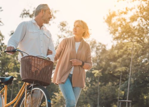 Older couple walking with a bicycle